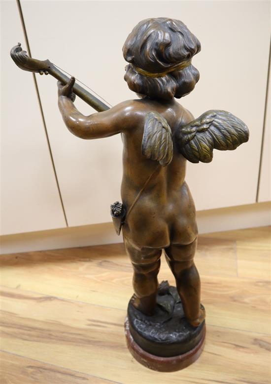 A patinated bronze statuette, cherub playing a lute, base signed, 58cm